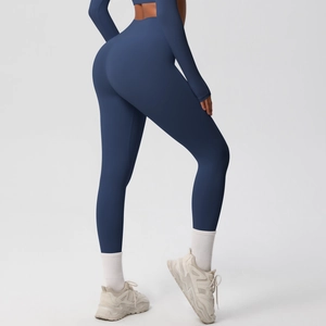 Detail view of high-waisted dark blue yoga leggings with seamless body-shaping effect
