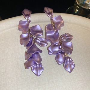 Close-up detail of elegant lavender petal drop earrings with metallic satin finish