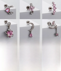 Macro shot of titanium steel cartilage studs with pink zircon hearts and stars