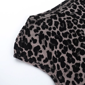 Detailed close-up of leopard print mesh fabric with flocking texture on short sleeve top