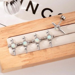 5-piece set of silver cross stud earrings with heart opal stones on a wooden jewelry display