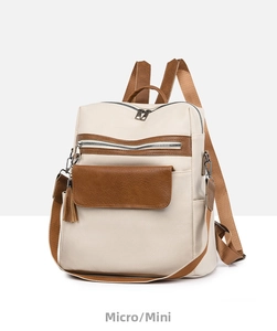 Side view of beige PU leather backpack featuring brown straps and tassel detail