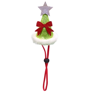 Detail of Christmas pet hat with green glitter fabric, red bow, and silver star top