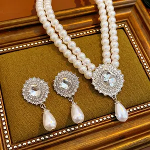 Double-layer pearl necklace and teardrop earrings set with square rhinestones