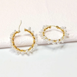 Elegant gold hoop earrings with small white pearls and handcrafted wire wrapping