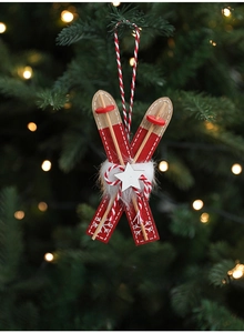 Detail of red wooden ski ornaments with white fur on a festive Christmas tree