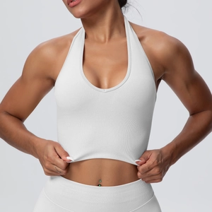 Detail of white halter neck seamless sports bra featuring ribbed hem and elastic knit fabric