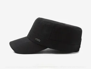 Detail of black military flat top hat showing twill texture and silver fashion emblem