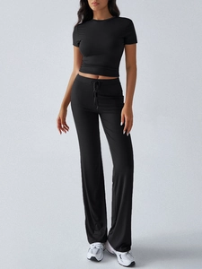 Detail view of women's black two-piece set featuring a cropped T-shirt and flare pants