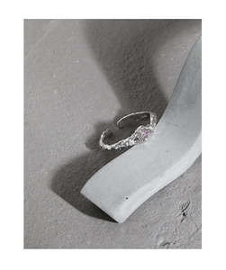 Close-up of S925 sterling silver lava texture ring featuring a small pink gemstone
