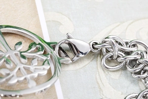Macro shot of stainless steel tree of life pendant with sturdy lobster clasp closure