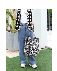 Close-up of leopard print canvas tote bag with large capacity in a street style setting