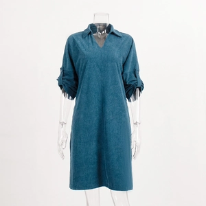 Detail of teal corduroy midi dress showing V-neck design and textured ribbed fabric