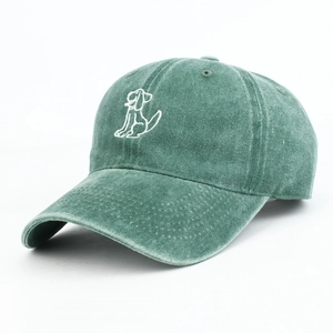 Close-up of embroidered cartoon dog on dark green washed cotton baseball cap