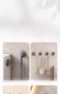 Strong suction cup hook in gunmetal grey shown holding a brush on bathroom wall