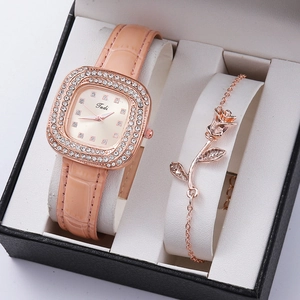 Detail view of rose gold square watch and floral bracelet in a premium gift box