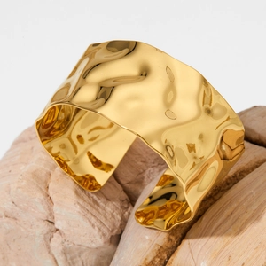 Minimalist wide gold-plated stainless steel cuff bracelet with irregular hammered texture