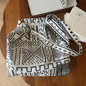 Detailed view of bohemian canvas tote bag with geometric patterns on a wooden table