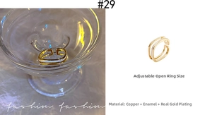 Detail of adjustable gold ring with white enamel inlay and double-line open design