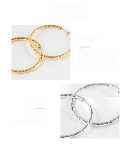 Close-up of gold and silver hammered hoop earrings showing vacuum plating texture