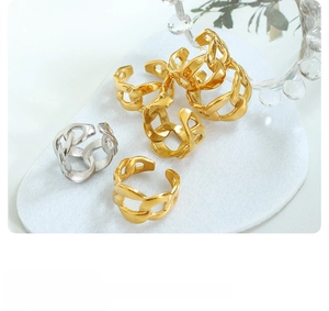 Close-up of chunky chain link open rings in gold and silver finish on white felt