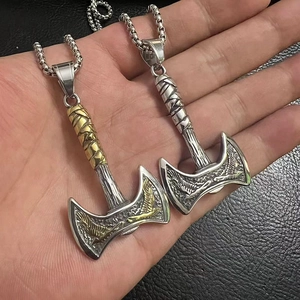 Detail of Viking double axe pendants with eagle carving and textured box chain