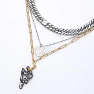 Close-up of three-layer mixed metal necklace with coin portrait and zircon lightning charms