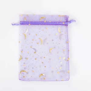 Close-up of purple organza gift bag with gold star and moon foil patterns and drawstring