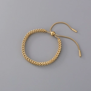 Adjustable golden wheat chain bracelet with a polished sliding ball clasp and metal texture