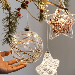Illuminated glass ball ornament with LED string lights for Christmas tree decoration