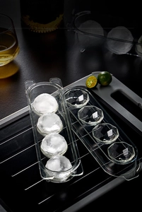 Close-up of diamond-shaped ice cubes in a 4-hole transparent food-grade mold