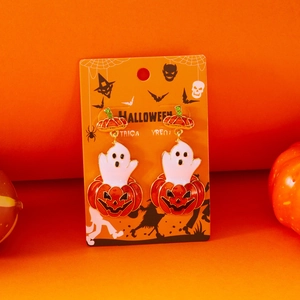 Detail of Halloween pumpkin and ghost earrings on a festive orange background card
