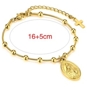 Detailed view of gold rosary bracelet with Virgin Mary medal and cross pendants