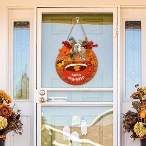Autumn harvest round wooden door sign with hello pumpkin lettering and maple leaf decor