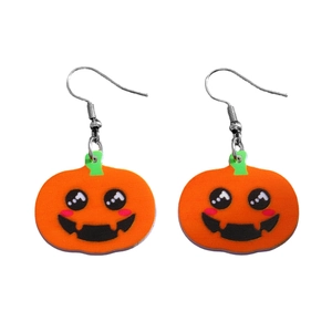 Detail of Halloween pumpkin acrylic earrings with cute cartoon faces and orange finish