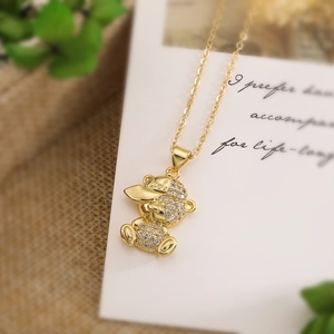 Gold plated bear necklace with white zircons and 'Cool' engraved hat pendant