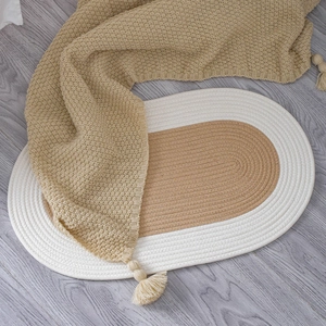 Oval handwoven cotton rug in khaki and beige tones for minimalist home decor