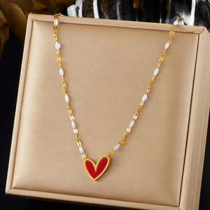Gold-plated stainless steel chain necklace with a red enamel heart pendant on a gift box
