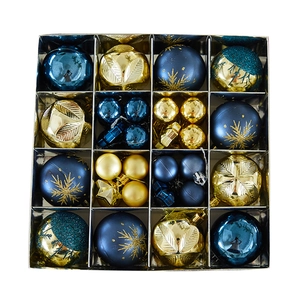 Blue and gold Christmas bauble set with snowflake patterns and assorted textures in a box