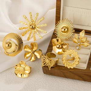 Golden flower and butterfly ring set with sunburst design on white velvet lining