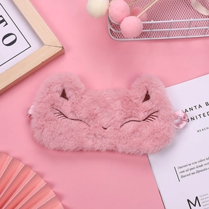 Close-up of a pink plush animal eye mask with soft fabric and elastic strap detail