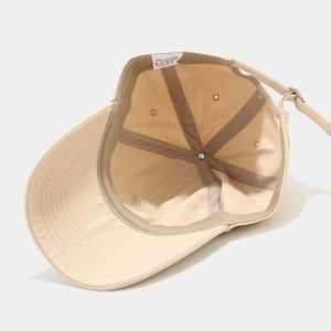 Inside view of beige cotton smiley baseball cap showing stitching and inner structure