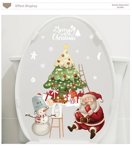 Detailed view of Santa and Snowman Christmas toilet lid decals on white bathroom surface