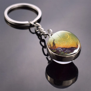 Detail of silver metal keychain featuring Van Gogh Starry Night art in glass dome