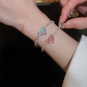 Close-up of heart-shaped zircon bracelet with micro-paved crystals on a model wrist