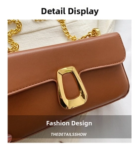 Detailed close-up of brown faux leather shoulder bag with gold metal buckle and chain