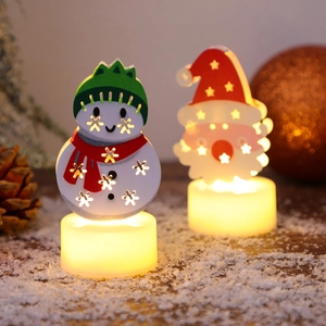 Festive Christmas LED candle lights featuring Santa and Snowman in a warm snow setting