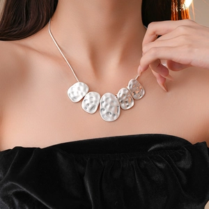 Minimalist silver wrinkled oval necklace with hammered irregular metal pendants