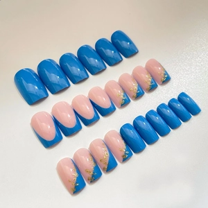 Blue and nude pink press-on nails set with french tips and gold foil glitter accents