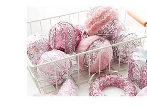 Close-up of pink Christmas ornaments with glitter, beads and soft faux fur textures